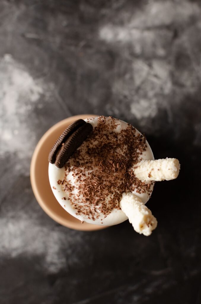 Oreo Easter milkshake topped with whipped cream, chocolate shavings, Oreo cookies, and wafer sticks.